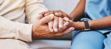 Nurse, hands and senior patient in empathy, safety and support of help, trust and healthcare consulting. Nursing home, counseling and gratitude for medical caregiver, client and hope in consultation.